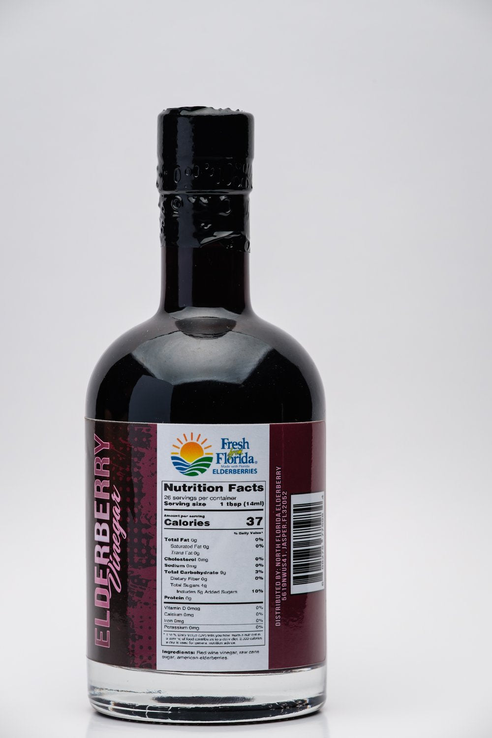 Bottle of North Florida Elderberry Balsamic Vinegar and label on a white background