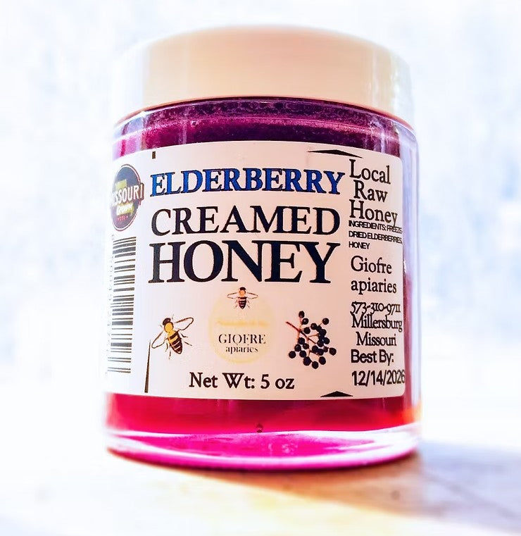 Jar of creamed honey with a label on a white background