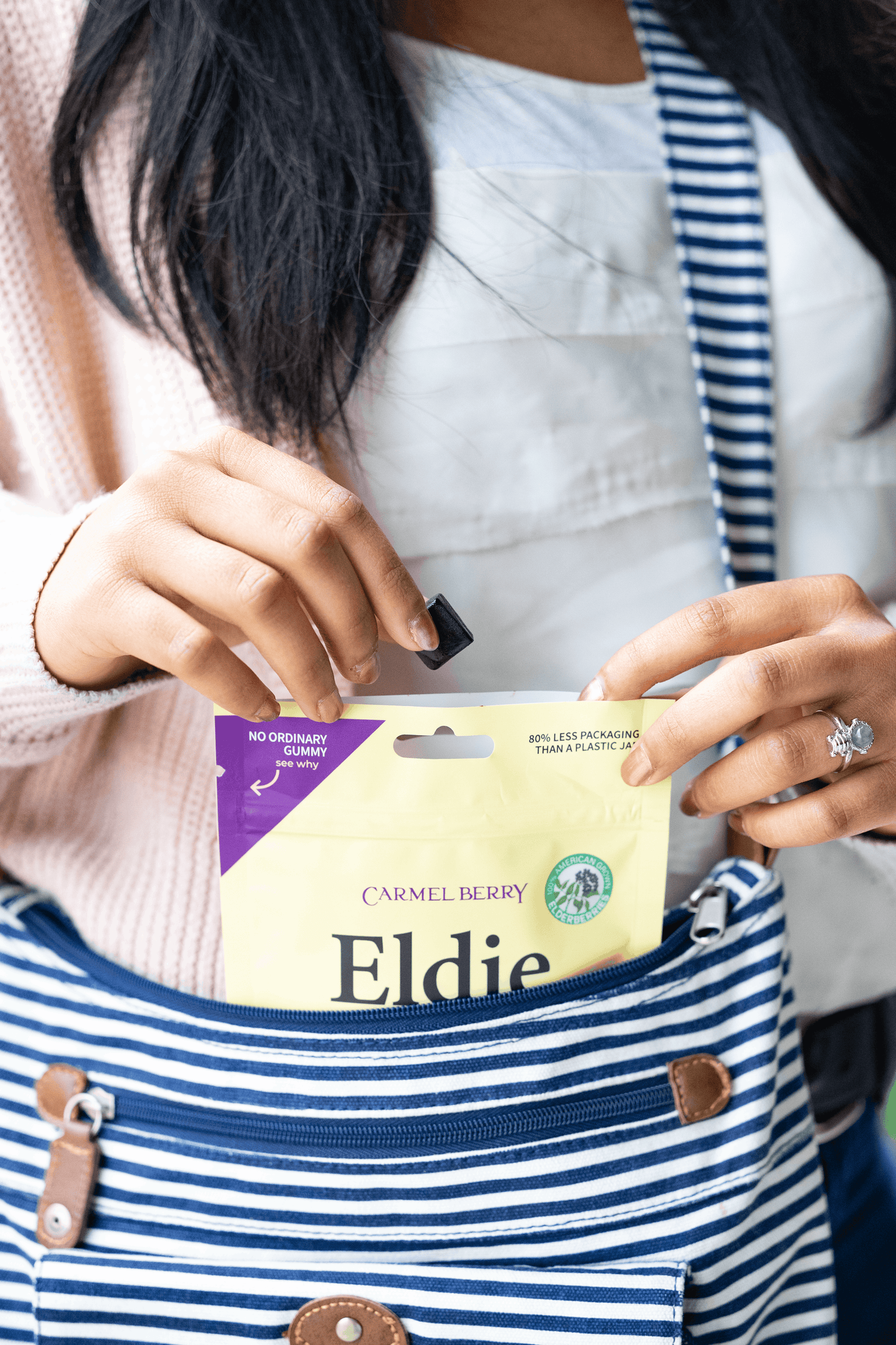 Person holding a package labeled 'Eldie' with a focus on the product.