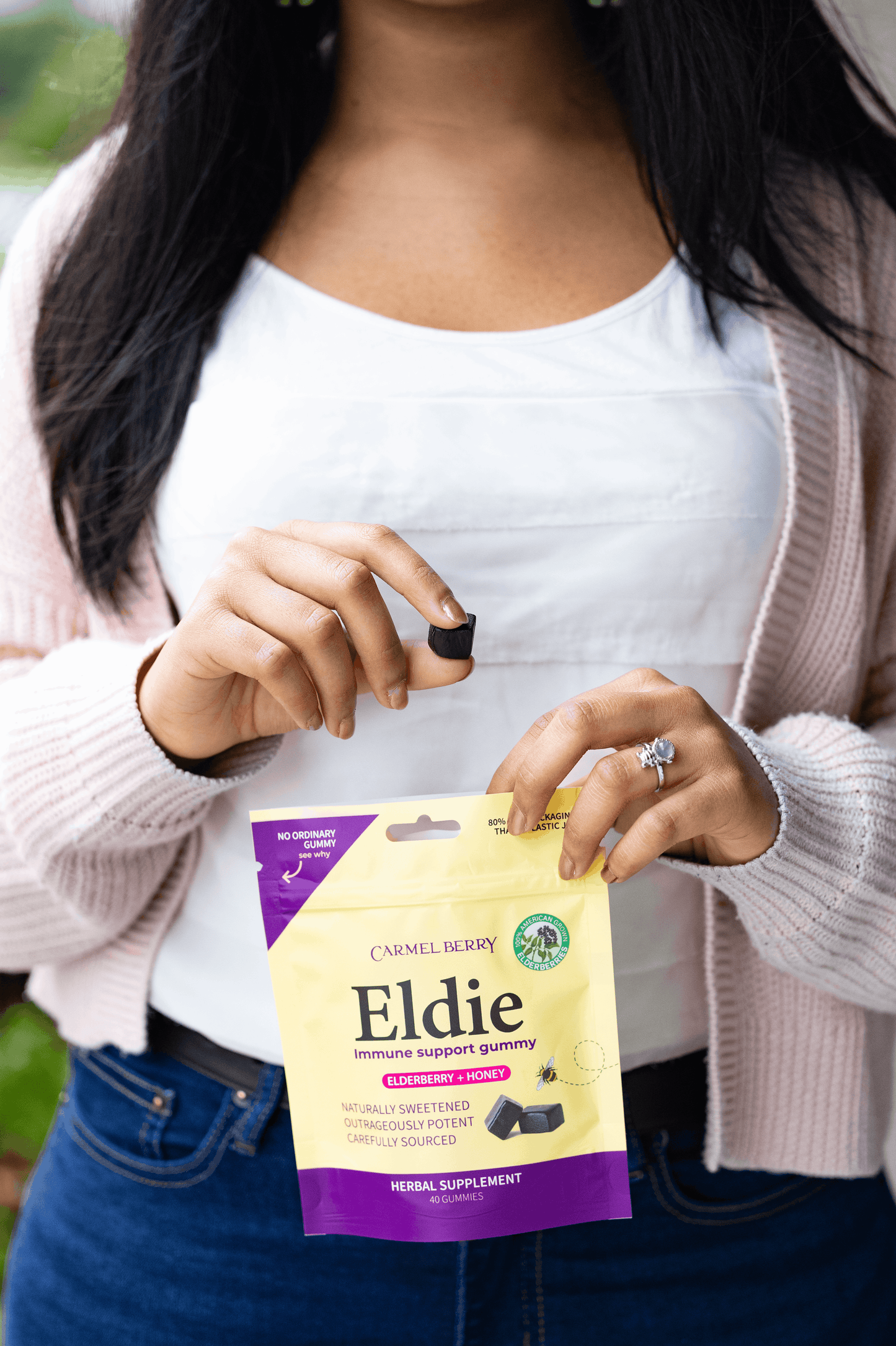 Person holding a package of Eldie herbal supplement