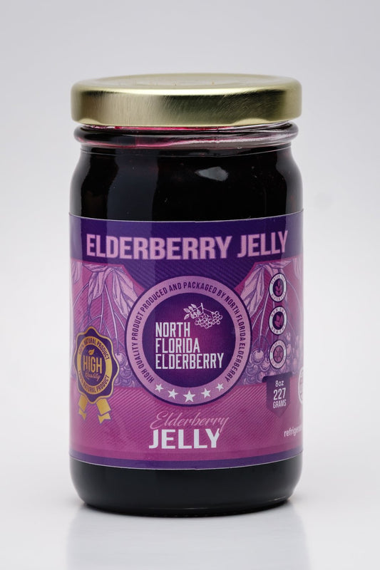 Jar of elderberry jelly with a purple label on a white background