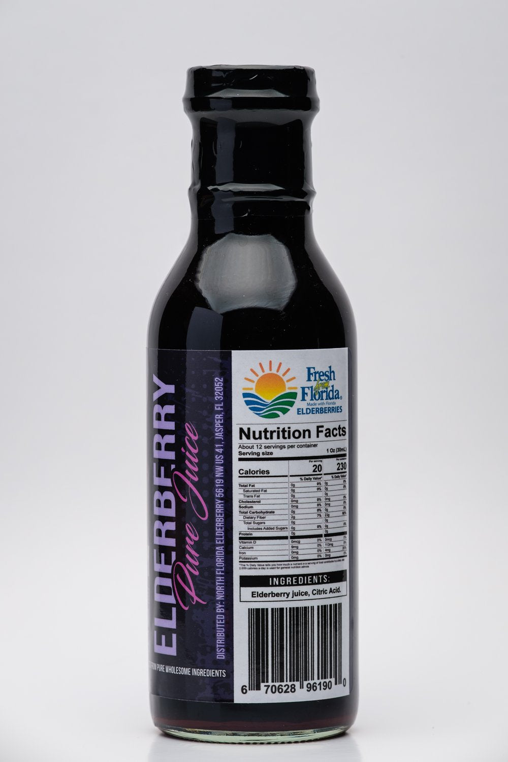 Bottle of elderberry pure juice with a label on a white background