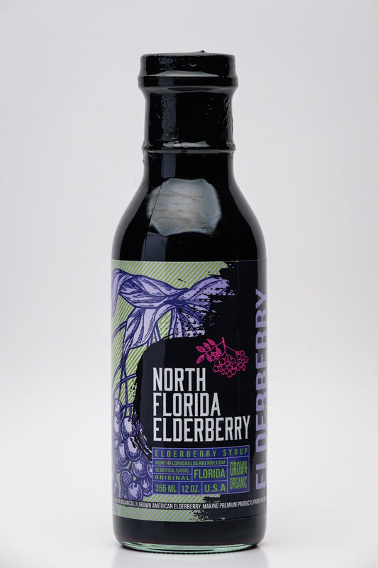 Bottle of North Florida Elderberry syrup with a label featuring elderberry graphics on a white background.