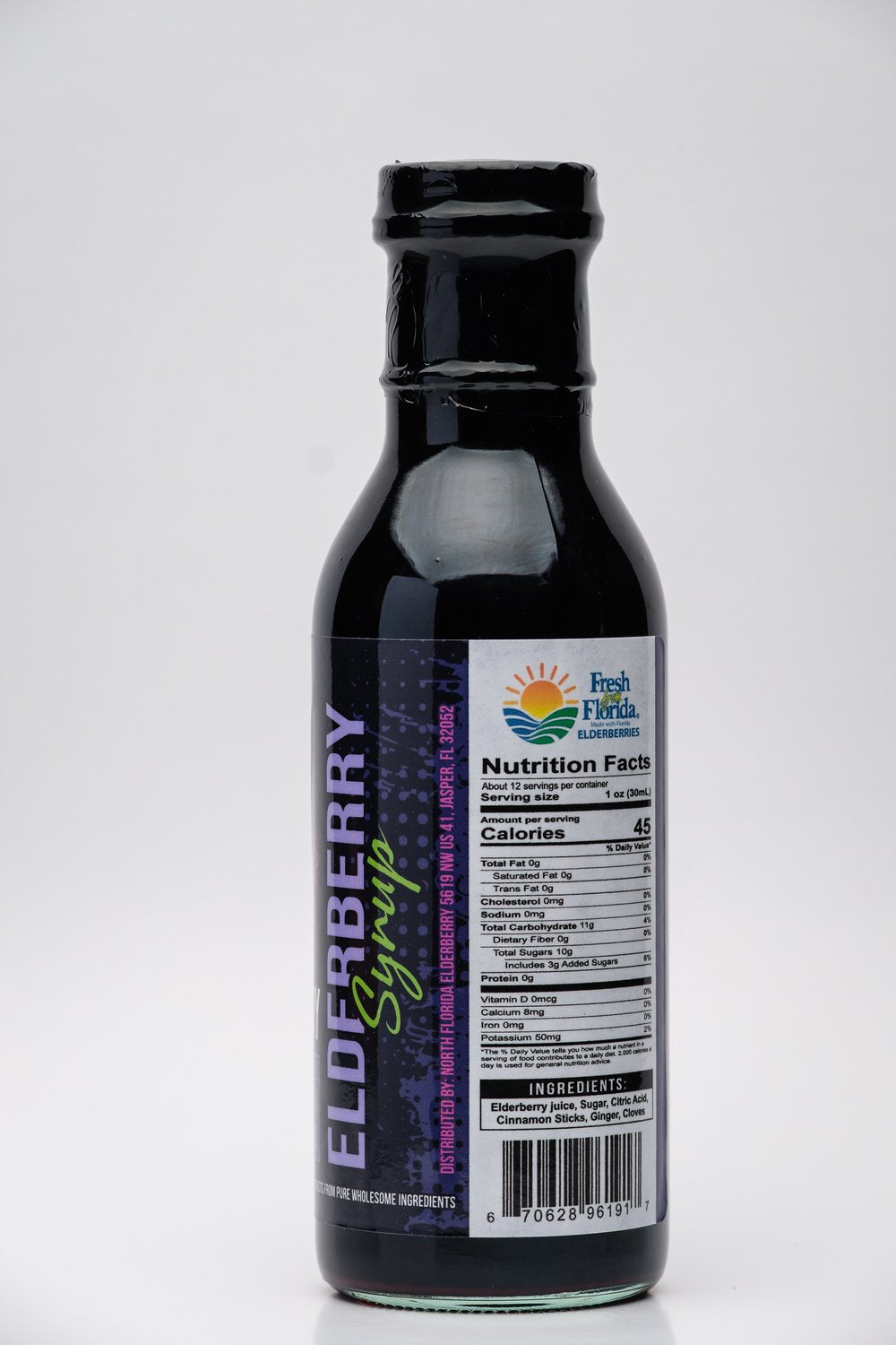 Bottle of elderberry syrup with label on a white background