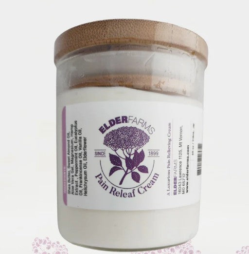 Jar of Elder Farms Pain Releaf Cream with wooden lid on a white background
