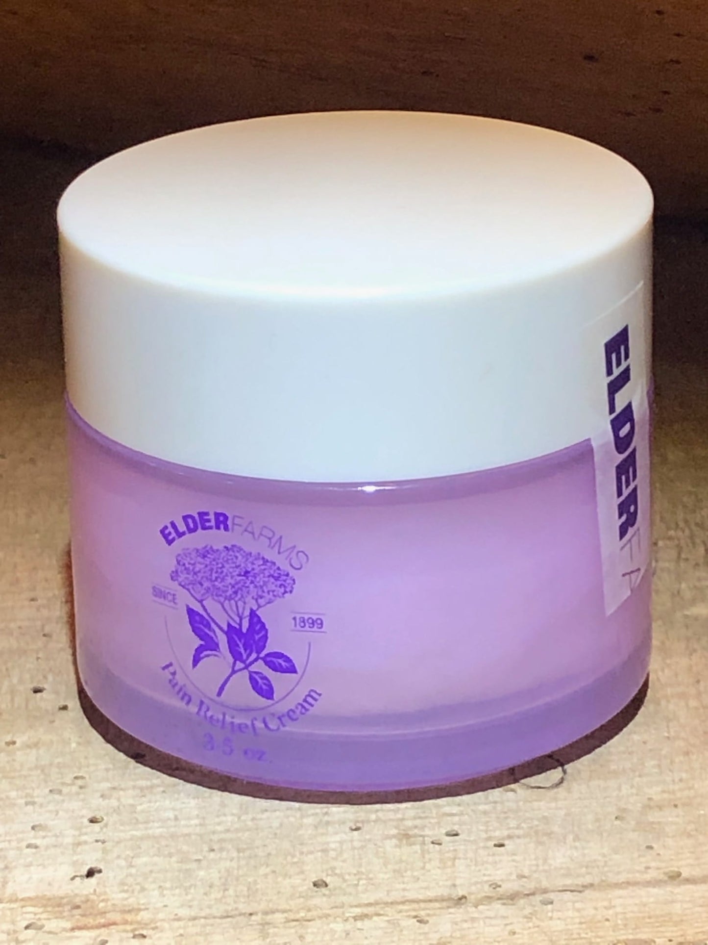 Pain_Releaf_Cream_Bottle_Side_Seal_On_Table3